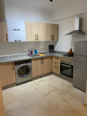 a kitchen with a washer and a dishwasher in it at Superbe appartement uniquement pour les familles in Marrakech