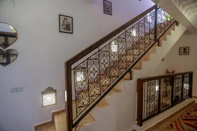 a staircase with wrought iron railings in a house at Riad Beni Sidel in Marrakech