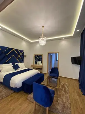 a bedroom with a king sized bed and a chandelier at Villa 7palms in Marrakech