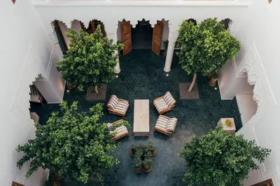 an overhead view of a courtyard with trees and chairs at Riad no37 in Marrakech