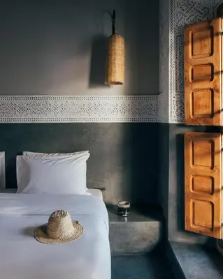 a bedroom with a bed with a hat on it at Riad no37 in Marrakech