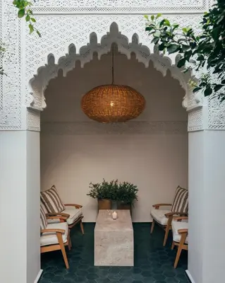 a room with chairs and a table and a ceiling at Riad no37 in Marrakech