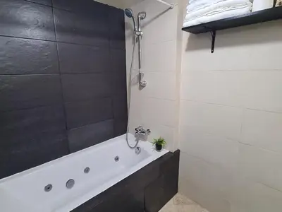 a bathroom with a bath tub and a shower at appartement in Marrakech