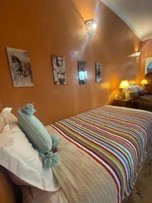 a bedroom with a large bed in a room at Riad Dar Teranga Hotel & Spa in Marrakech