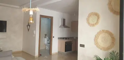 a room with a toilet and a kitchen with a hallway at Apparemment wafaa in Marrakech