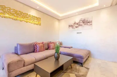 a living room with a couch and a table at NEW! Luxe et moderne en plein Guéliz, Terrasse in Marrakech