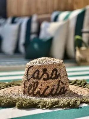 a straw hat sitting on top of a table at Riad Casa Felicità & SPA in Marrakech