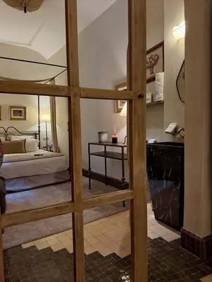 a view of a bedroom with a bed through a glass door at Riad Casa Felicità & SPA in Marrakech