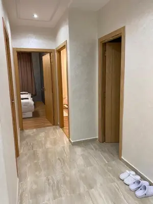 a hallway with two pairs of shoes on the floor at Appartement a loué pour les familles in Marrakech
