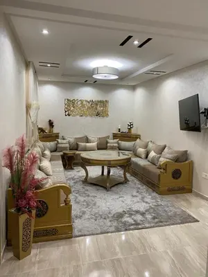 a large living room with couches and a table at Appartement a loué pour les familles in Marrakech