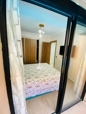a view of a bedroom through a glass window at appart à côté de la gare du train in Marrakech