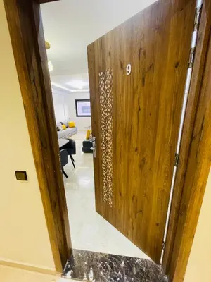 a wooden door leading into a living room at appart à côté de la gare du train in Marrakech