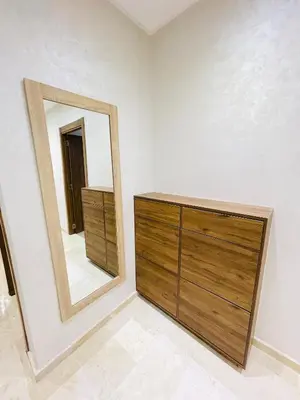 a bedroom with a dresser and a mirror at appart à côté de la gare du train in Marrakech