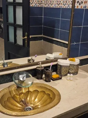 a bathroom counter with a sink and a mirror at Luxueux appartement Marrakech au cœur de l hivernage in Marrakech