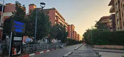 an empty street in a city with tall buildings at Luxueux appartement Marrakech au cœur de l hivernage in Marrakech