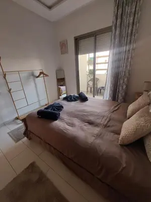 a bedroom with a large bed and a large window at Morooco Home in Marrakech