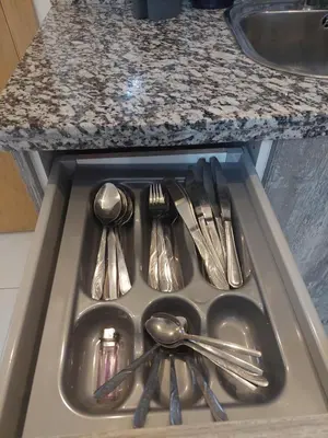 a drawer with utensils in a sink in a kitchen at Morooco Home in Marrakech