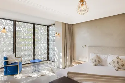 a bedroom with a bed and a large window at Villa de luxe Sahara in Marrakech