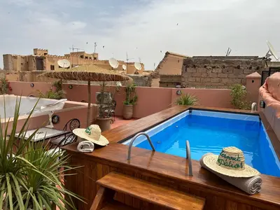 a swimming pool on a balcony with hats on it at Riad l'Esprit des Patios & Spa in Marrakech