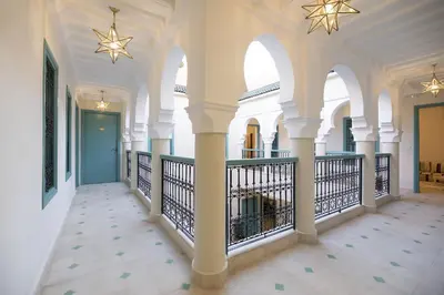 a hallway of a building with columns and ceilings at Riad l'Esprit des Patios & Spa in Marrakech