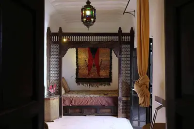 a living room with a fireplace with the letter m on it at Riad Dar Dallah in Marrakech