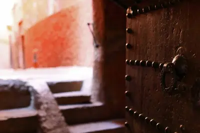 an open wooden door with a stairway in the background at Riad Dar Dallah in Marrakech