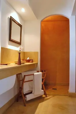 a bathroom with a sink and a table with a towel at Riad Dar Dallah in Marrakech