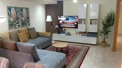 a living room with a couch and a tv at Beautiful, great equipped 122 m holiday apartment near Majorelle Garden and Gueliz with pool views and a large balcony and terrace in Marrakech