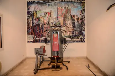 a room with a painting on the wall and a red chair at Beautiful, great equipped 122 m holiday apartment near Majorelle Garden and Gueliz with pool views and a large balcony and terrace in Marrakech