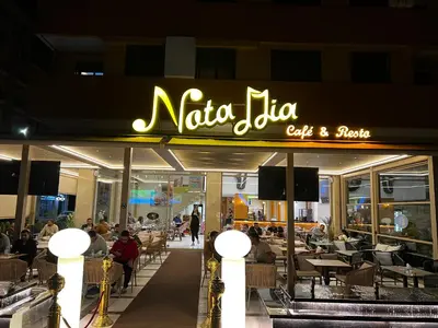 a restaurant with a sign that reads nato jio cuisine at Beautiful, great equipped 122 m holiday apartment near Majorelle Garden and Gueliz with pool views and a large balcony and terrace in Marrakech