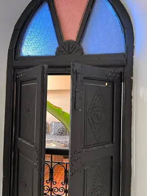 a black door with a window in a room at Riad Black Doors in Marrakech