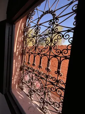 a view of a window with a wrought iron gate at Riad Black Doors in Marrakech