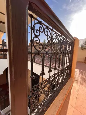 a iron gate on a balcony with a view at Riad Black Doors in Marrakech