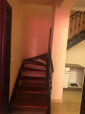 a staircase in a room with a stair case at Propre appartement à loué pour les familles in Marrakech