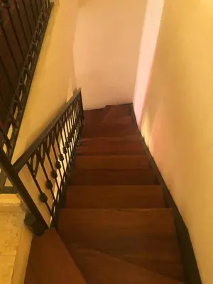 a staircase leading up to a building with wooden stairs at Propre appartement à loué pour les familles in Marrakech