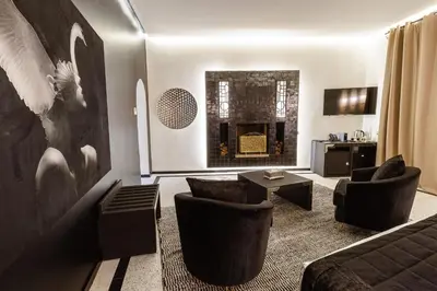 a living room with a couch and chairs and a fireplace at Palais Anthea Boutique Hotel & Spa in Marrakech