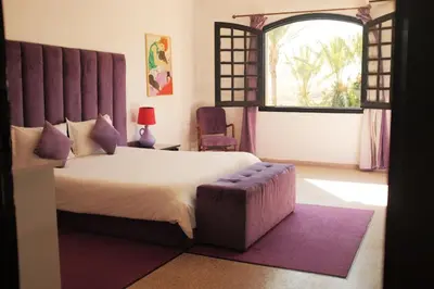 a bedroom with a large bed and a window at Villas Green in Marrakech
