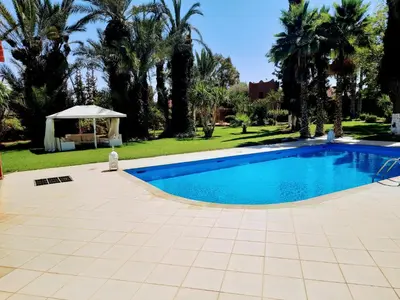 a swimming pool in a yard with a gazebo at Villas Green in Marrakech