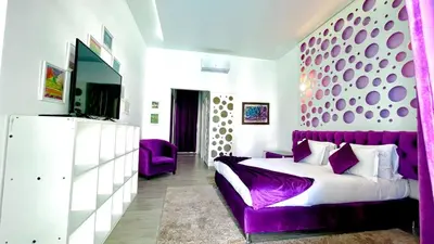 a bedroom with a purple bed and a purple couch at Villas Green in Marrakech