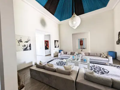 a living room with couches and a blue ceiling at Villas Green in Marrakech