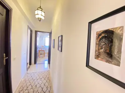 a hallway with a painting on the wall and a picture on the wall at Appartement Dalila in Marrakech