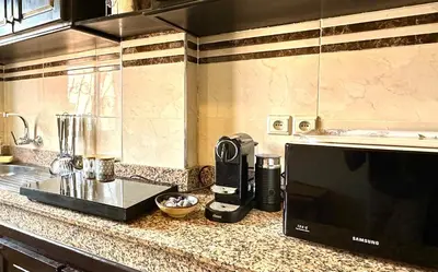 a kitchen with a counter top with a blender and a microwave at Appartement Dalila in Marrakech