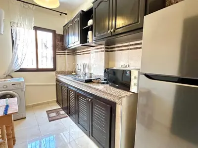 a kitchen with a refrigerator and a sink in it at Appartement Dalila in Marrakech