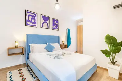 a blue and white bedroom with a blue bed at Magnificent Apartment in Gueliz - 100% Equipped in Marrakech
