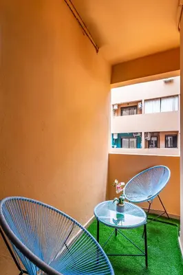 two blue chairs and a table on a balcony at Magnificent Apartment in Gueliz - 100% Equipped in Marrakech