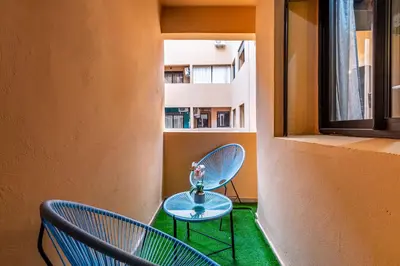 a room with two chairs and a table and a window at Magnificent Apartment in Gueliz - 100% Equipped in Marrakech