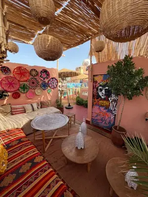 a living room with a couch and tables at Riad Fz Marrakech in Marrakech