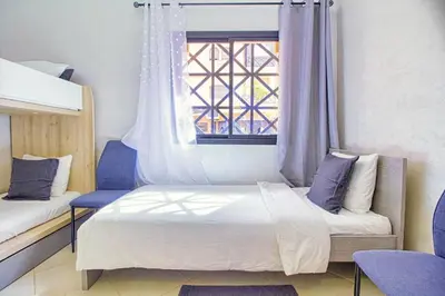 a bedroom with two beds and a window at Les Jardins Sakar - Marrakech - Deux Chambres Exceptionnelle in Marrakech