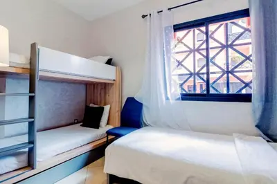 two bunk beds in a room with a window at Les Jardins Sakar - Marrakech - Deux Chambres Exceptionnelle in Marrakech