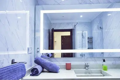 a bathroom with a sink and a large mirror at Les Jardins Sakar - Marrakech - Deux Chambres Exceptionnelle in Marrakech